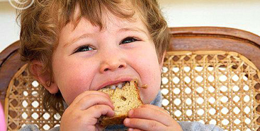Boy eating a peanut butter sandwich